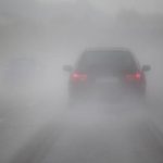 driving car on the motorway with heavy rain and fog