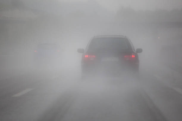 driving car on the motorway with heavy rain and fog